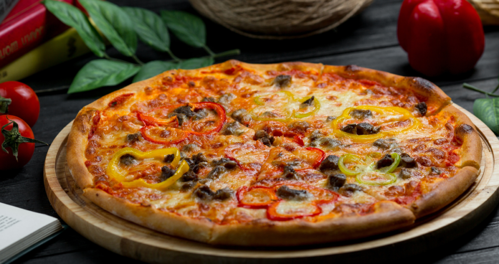 Close-up of a freshly baked Pickle Pie Pizza with melted cheese and sliced pickles on a crispy crust