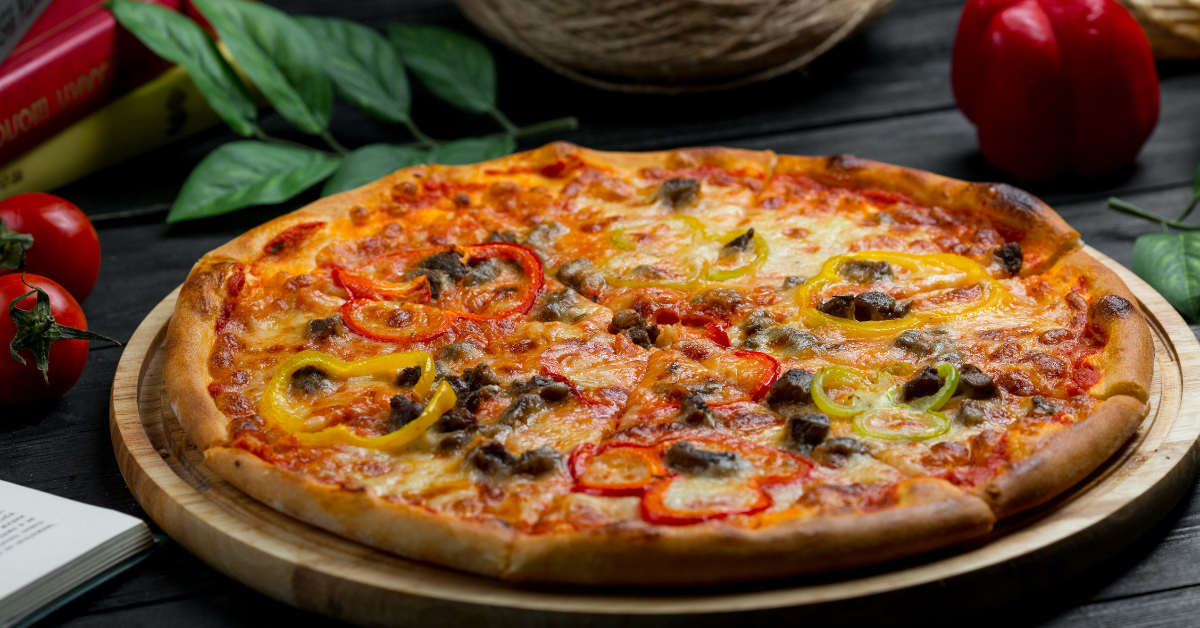 Close-up of a freshly baked Pickle Pie Pizza with melted cheese and sliced pickles on a crispy crust